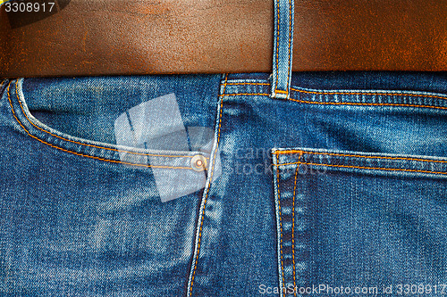 Image of blue jeans with belt, close up