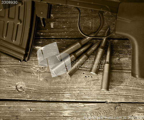 Image of sniper rifle and five cartridges