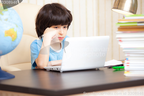 Image of boy looking at a computer monitor