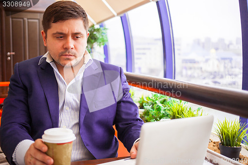 Image of businessman watching stock quotes