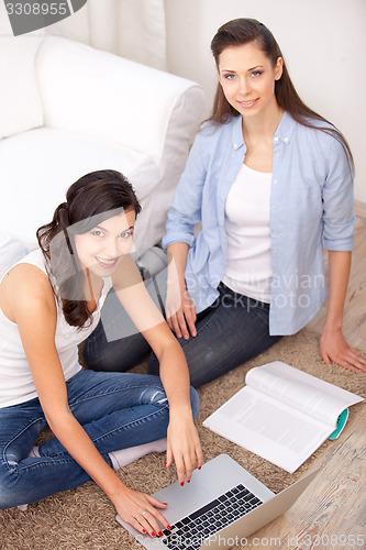 Image of Two girls and a laptop