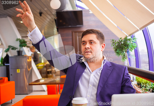 Image of Cafe visitor invites waiter