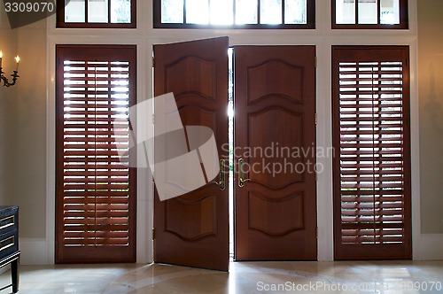 Image of door ajar with light shining in