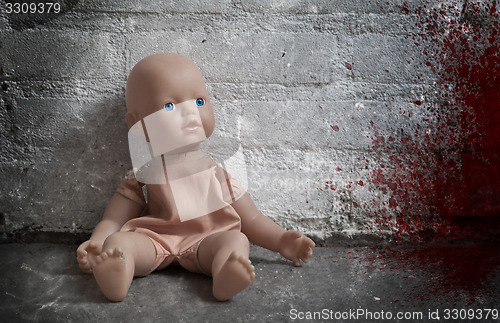 Image of Concept of child abuse - Bloody doll