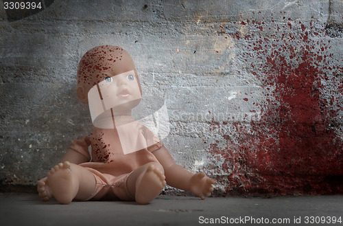 Image of Concept of child abuse - Bloody doll