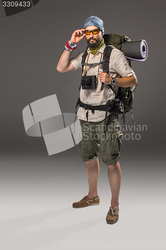 Image of Full length portrait of a male fully equipped tourist 