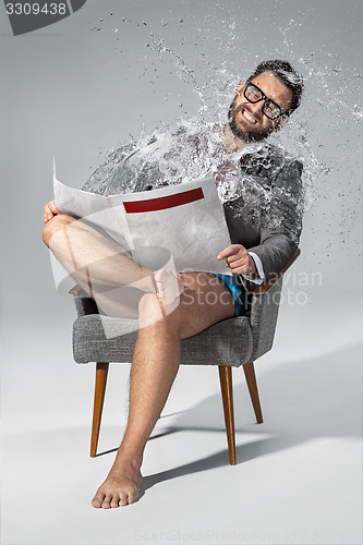 Image of Man reading newspaper on gray background