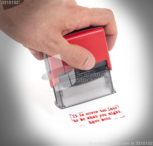 Image of Plastic stamp in hand, isolated