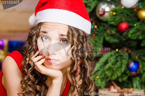 Image of Portrait of pensive girl in a Christmas setting