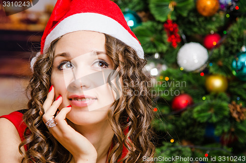 Image of Portrait of dreaming girl in a Christmas setting