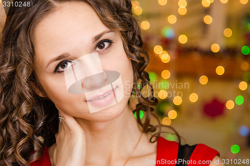 Image of Portrait girl on a background of blurred Christmas lights