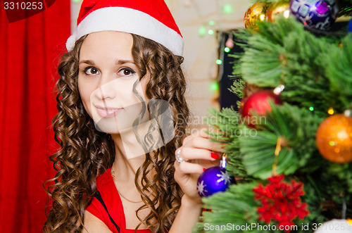 Image of young girl dresses up Christmas tree