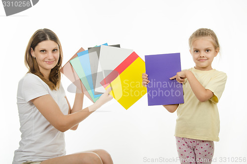 Image of girl and girl are holding colorful monochrome images