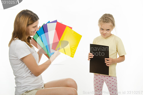 Image of Upset girl holding a black picture