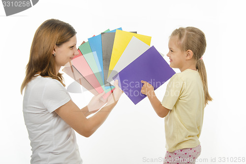 Image of child shows colors the image in hands of women