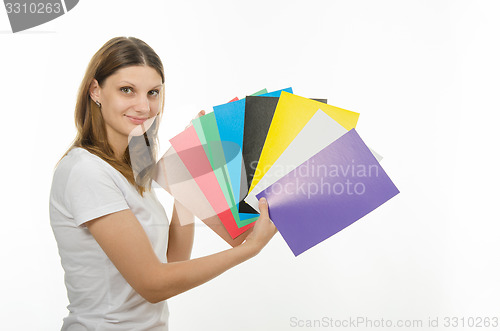 Image of young girl holding a picture with solid colors