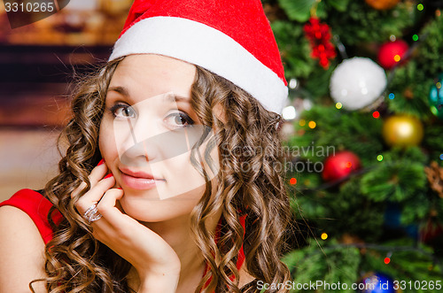 Image of Portrait of a cheerful girl in Christmas setting