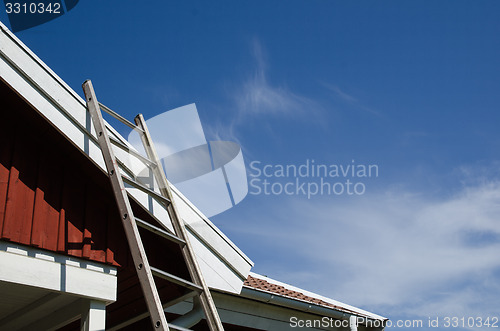 Image of Ladder at a tiled roof