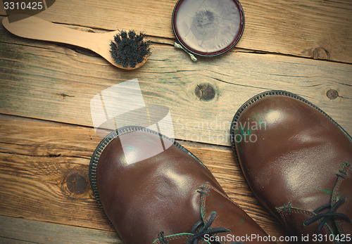 Image of Still life with brown boots, shoe polish and shoe brush