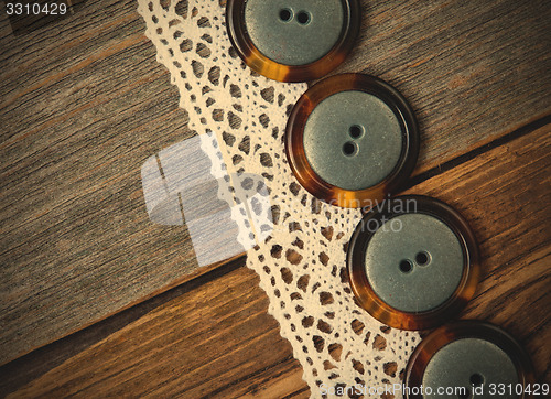 Image of vintage buttons and antique lace close up