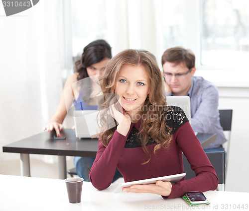 Image of smiling young girl with tablet