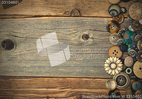 Image of vintage buttons on aged table