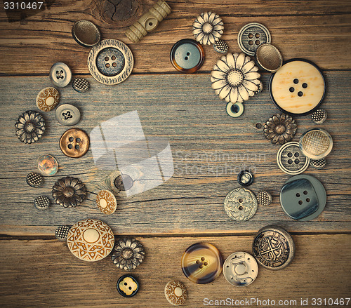 Image of several old buttons on the vintage table surface