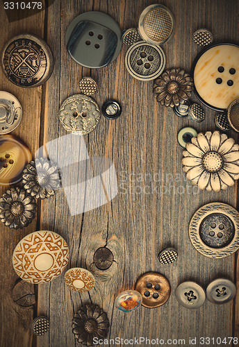 Image of vintage buttons on old wooden boards