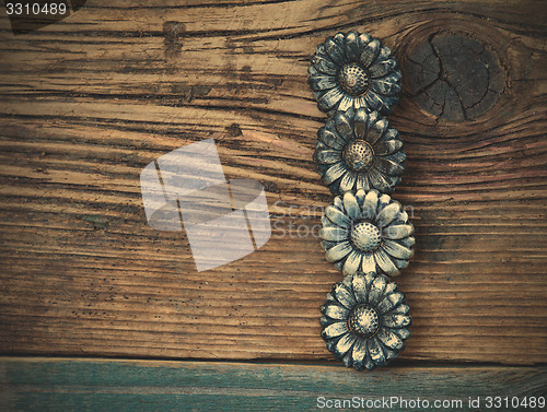 Image of four vintage buttons on wooden boards