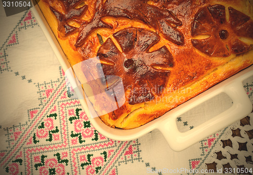 Image of cabbage pie on the embroidered cloth. Russian cuisine