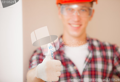 Image of worker showing thumb up