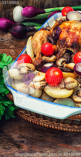 Image of baked whole chicken in vegetables
