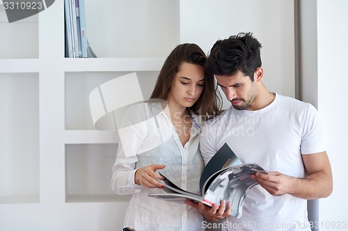 Image of relaxed young couple at home staircase