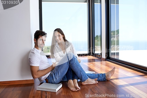 Image of relaxed young couple at home staircase