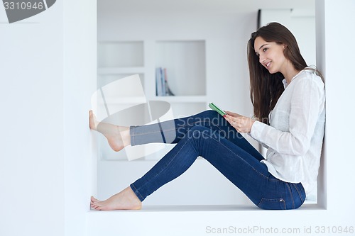 Image of woman at home using tablet