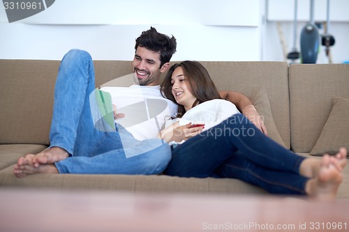 Image of couple at modern home using tablet computer