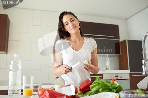 Image of Young Woman Cooking in the kitchen