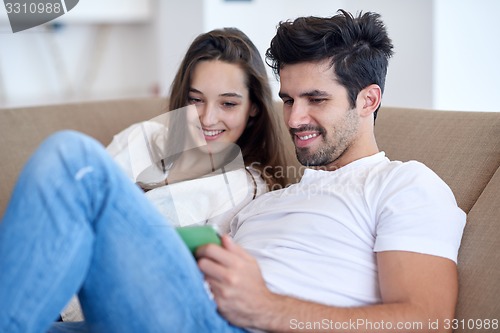 Image of couple at modern home using tablet computer
