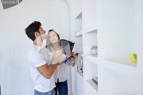 Image of relaxed young couple at home staircase