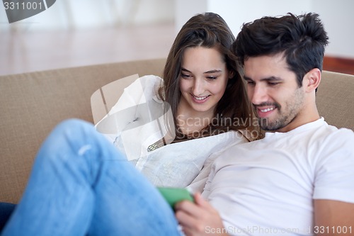 Image of couple at modern home using tablet computer