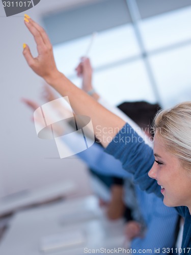 Image of students group raise hands up