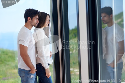 Image of relaxed young couple at home staircase