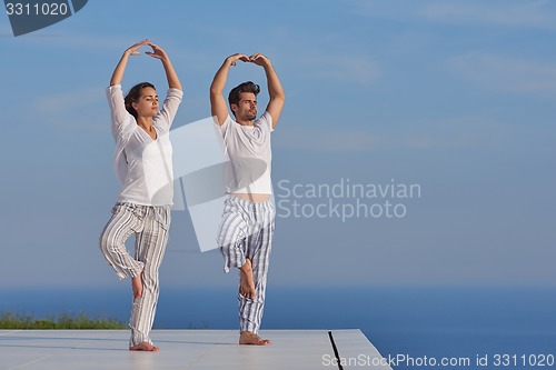 Image of young couple practicing yoga