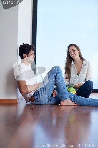 Image of relaxed young couple at home staircase
