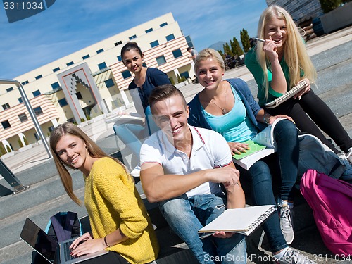 Image of students outside sitting on steps