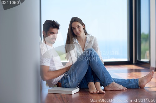 Image of relaxed young couple at home staircase