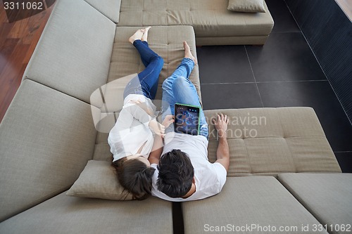 Image of couple at modern home using tablet computer