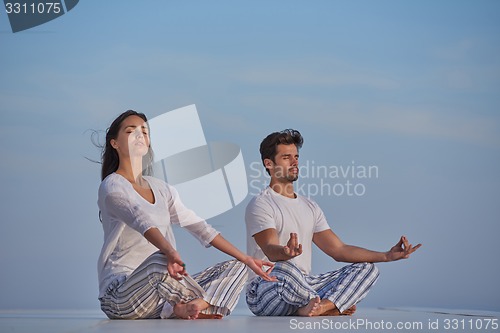 Image of young couple practicing yoga