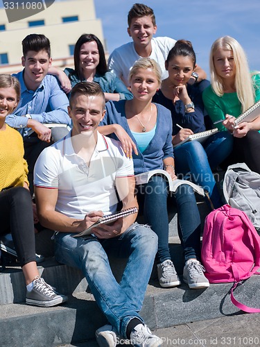 Image of students outside sitting on steps