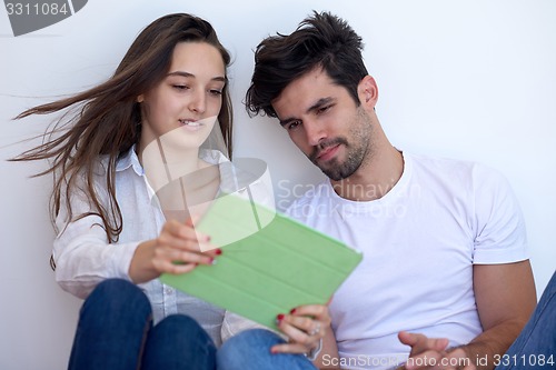 Image of couple at modern home using tablet computer